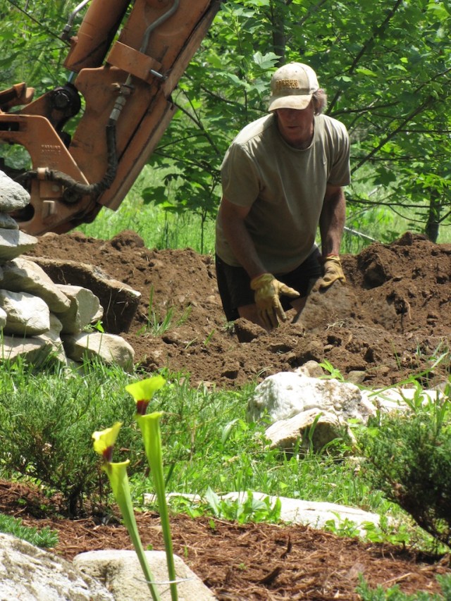 John worked right with the back hoe to pull out rocks for landscaping later.